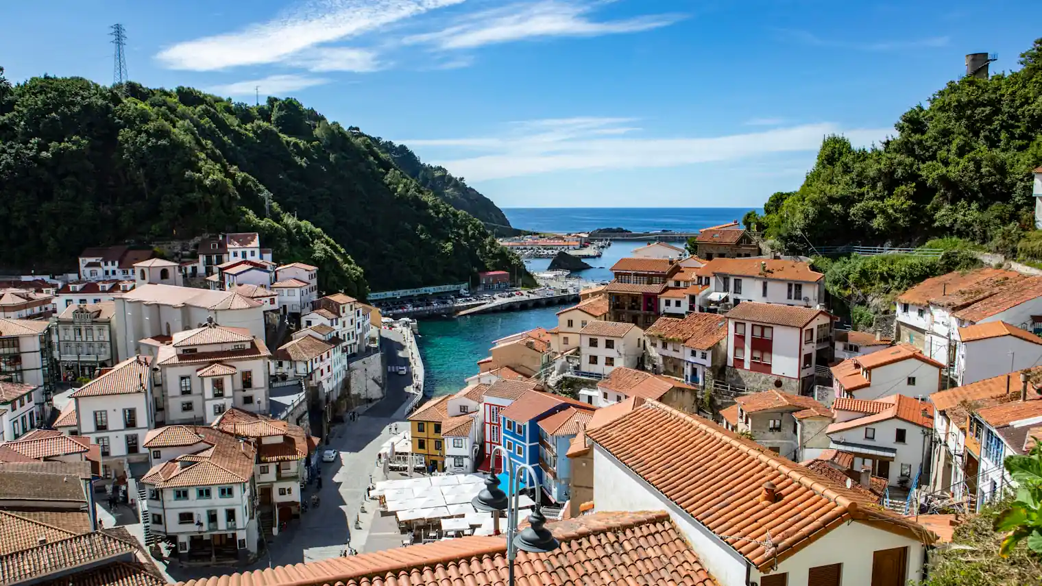 The amphitheatre of coloured houses at Cudillero in Asturias, wedged between green hillsides and the Atlantic