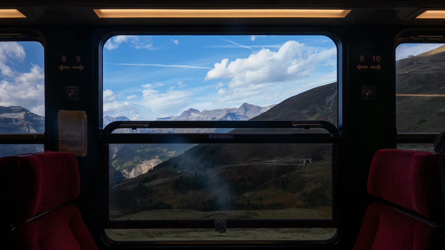 Mountain landscape seen through the window of a moving train