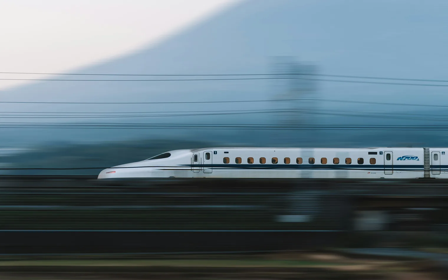 A Shinkansen bullet train passing below Mount Fuji, Shizuoka, Japan