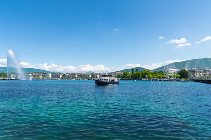 The Jet d'Eau fountain on Lake Geneva, Switzerland, with a lake boat in front