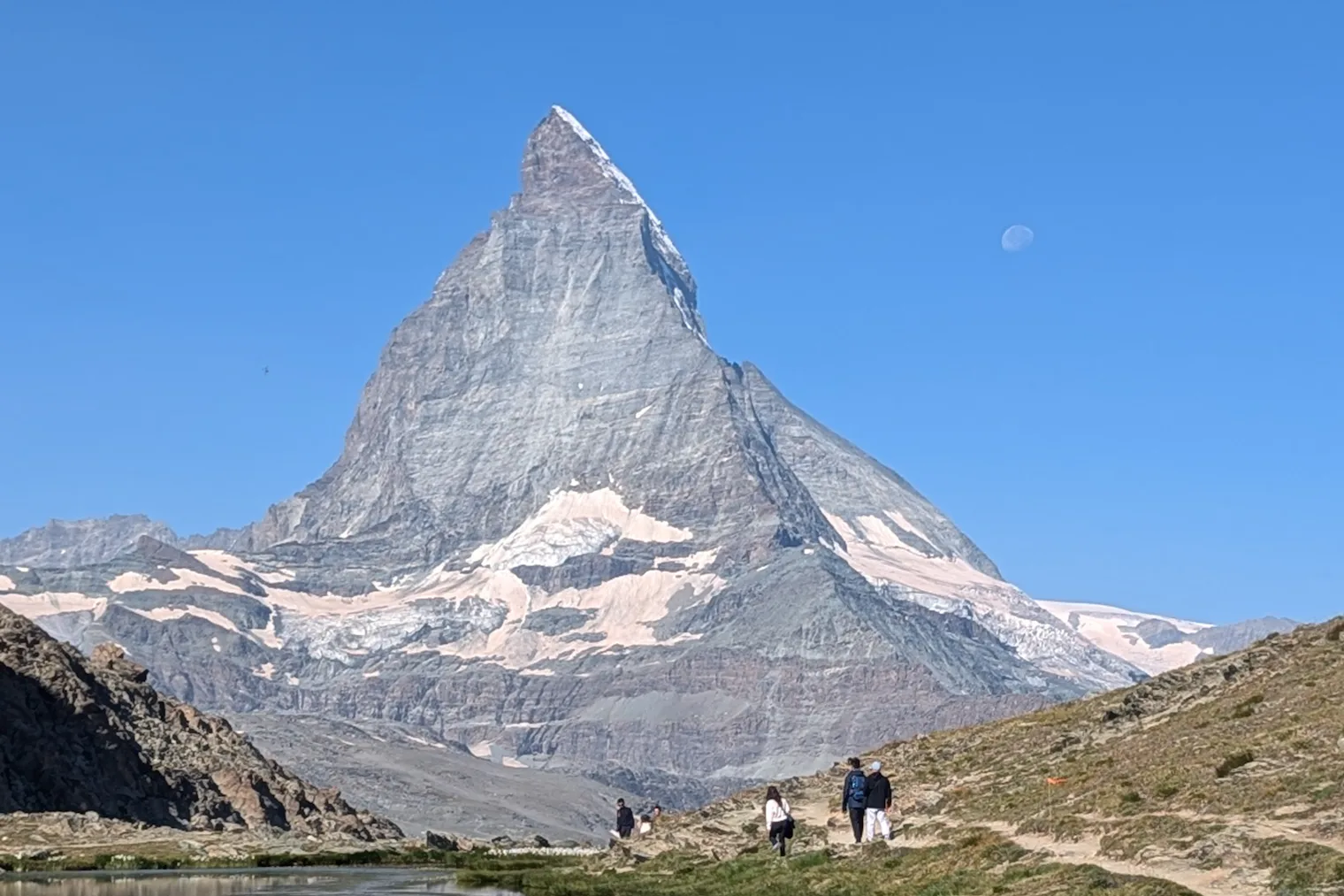 The Matterhorn above Zermatt, Switzerland, with hikers on the trail below