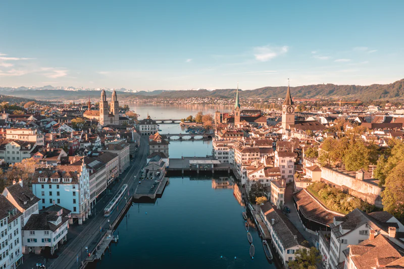 Zurich's old town along the Limmat river, with Lake Zurich and the Alps behind