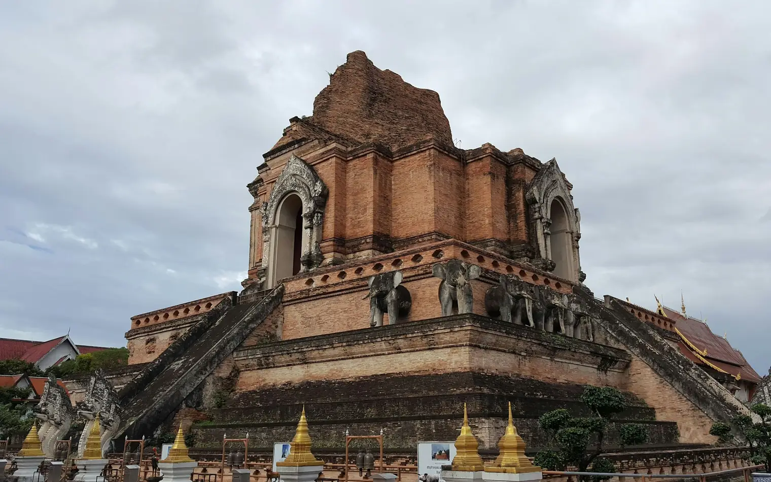 The ruined brick chedi of Wat Chedi Luang, with elephant sculptures, in Chiang Mai's old city, Thailand
