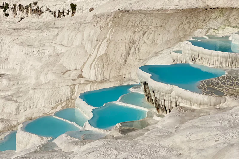 White travertine terraces and turquoise pools at Pamukkale, Turkey
